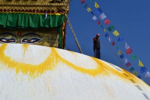 Pouring color in preparation for Holi, the celebration of colors. Yellow circle represents the buddhas third eye.